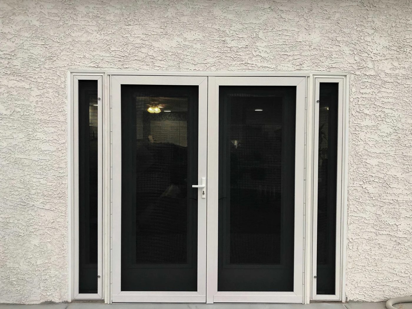 Stainless mesh security screens installed on a Sun Belt home